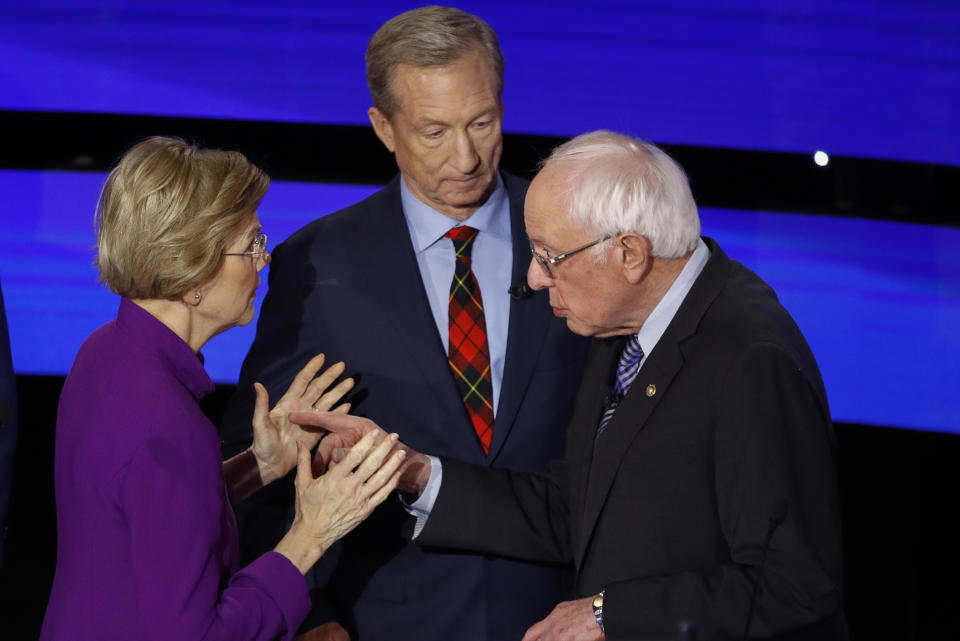 Elizabeth Warren and Bernie Sanders exchange words while Tom Steyer looks after Tuesday's Democratic primary debate in Des Moines. (AP Photo/Patrick Semansky)