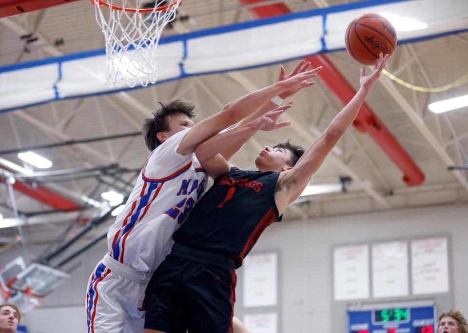 St. Johns' Anthony Dupuis, right, shoots against Mason's Levi Stambaugh, Friday, Jan. 6, 2023, in Mason.