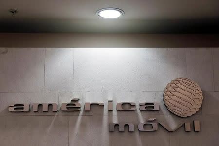 FILE PHOTO: The logo of America Movill is seen on a wall at the company's corporate offices in Mexico City, Mexico March 14, 2018. REUTERS/Carlos Jasso/File Photo