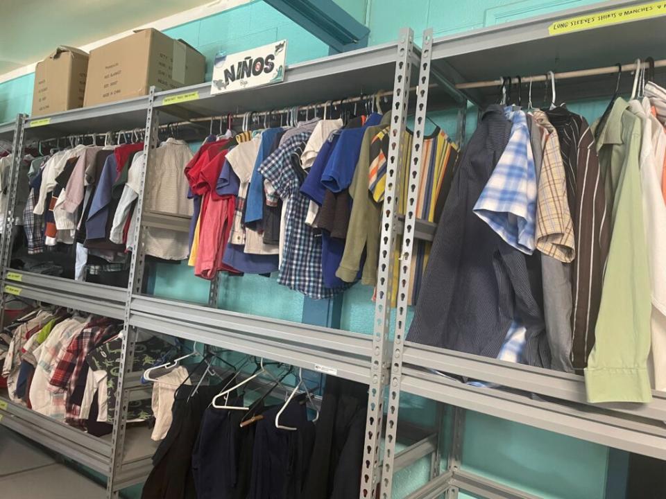  When migrants first arrive at the Sacred Heart Church shelter, they are allowed to pick out their own clothes in the “clothes closet,” which has items for infants, children and adults, donated by the El Paso community. (Photo by Ariana Figueroa/States Newsroom)