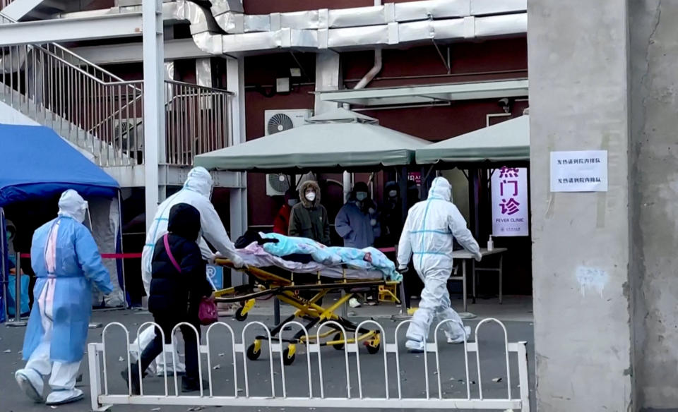 Medical staff moves a patient into a fever clinic at Chaoyang Hospital in Beijing, China December 13, 2022, in this screen grab taken from a Reuters TV video. REUTERS TV via REUTERS