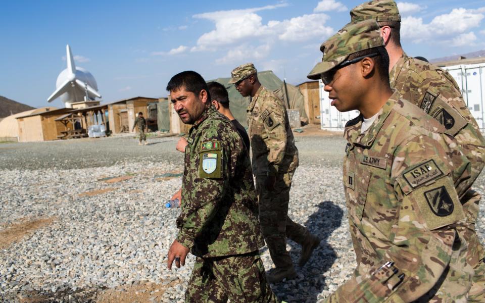 US army officers with an Afghan battalion commander in 2013