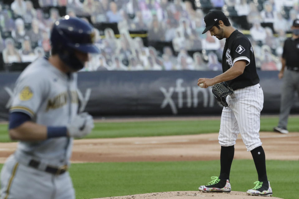 Chicago White Sox starting pitcher Gio Gonzalez, right, looks down as Milwaukee Brewers' Christian Yelich walks to firs4 during the first inning of a baseball game in Chicago, Thursday, Aug. 6, 2020. (AP Photo/Nam Y. Huh)