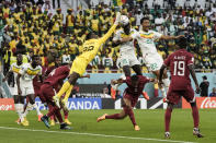 Qatar's goalkeeper Meshaal Barsham stops a shot during the World Cup group A soccer match between Qatar and Senegal, at the Al Thumama Stadium in Doha, Qatar, Friday, Nov. 25, 2022. (AP Photo/Hassan Ammar)