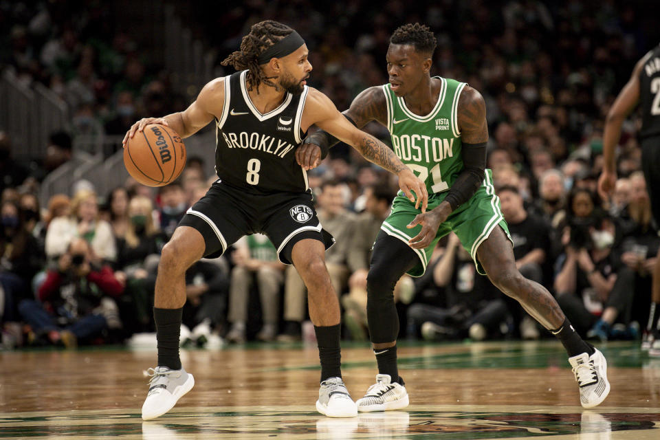 Seen here, Patty Mills of the Brooklyn Nets drives to the basket against Dennis Schroder of the Boston Celtics.