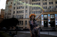 Eleven Alvarez poses for friends after graduating as a nutritionist, at a park amid the COVID-19 pandemic in Buenos Aires, Argentina, Wednesday, June 2, 2021. (AP Photo/Natacha Pisarenko)