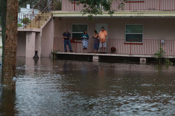 TARPON SPRINGS, FLORIDA - AUGUST 30: People look out at the flood waters from Hurricane Idalia surrounding their apartment complex on August 30, 2023 in Tarpon Springs, Florida. Hurricane Idalia is hitting the Big Bend area on the Gulf Coast of Florida. (Photo by Joe Raedle/Getty Images)