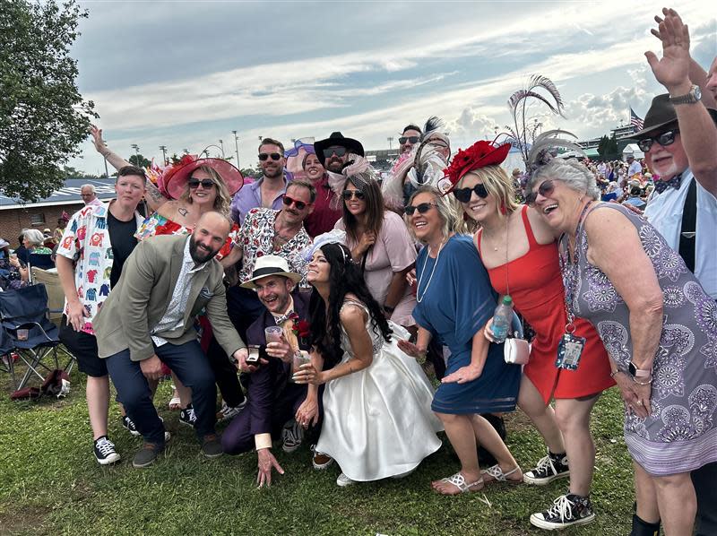 Eddy Stieren and Carrie Stobaugh (kneeling in front) were married Saturday in the Churchill Downs infield ahead of the 150th Kentucky Derby. May 4, 2024