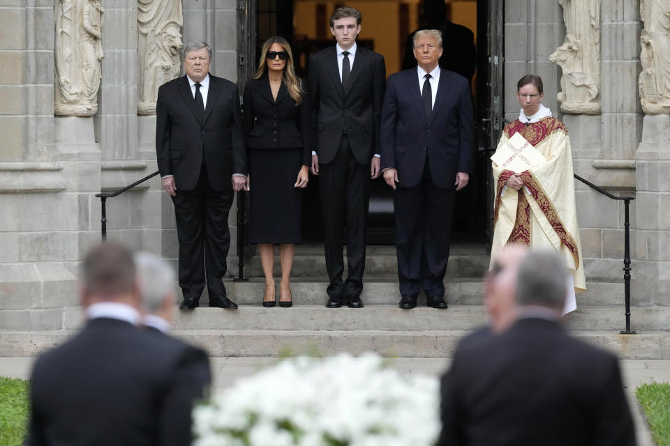 Former President Donald Trump, center right, stands with his wife Melania, second left, their son Barron, center, and father-in-law Viktor Knavs, left, as the coffin carrying the remains of Amalija Knavs, the former first lady's mother, is carried into the Church of Bethesda-by-the-Sea for her funeral, in Palm Beach, Fla., Thursday, Jan. 18, 2024. (AP Photo/Rebecca Blackwell)