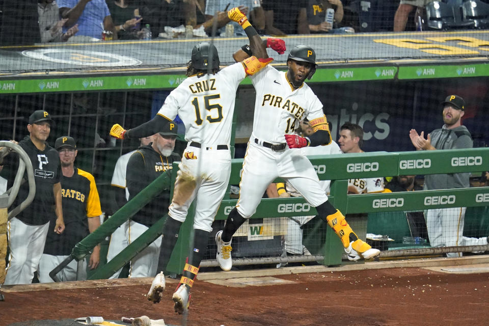 Pittsburgh Pirates' Oneil Cruz (15) celebrates with Rodolfo Castro (14) as he returns to the dugout after hitting a solo home run off St. Louis Cardinals relief pitcher JoJo Romero during the seventh inning of a baseball game in Pittsburgh, Saturday, Sept. 10, 2022. (AP Photo/Gene J. Puskar)