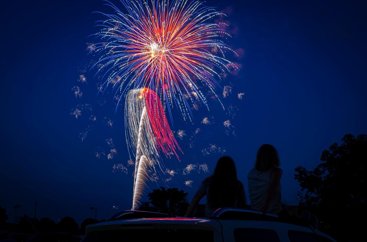 Fireworks explode over Pleasant Plains High School as people take in the show from the roof of their car, Friday, July 3, 2020, in Pleasant Plains, Ill. [Justin L. Fowler/The State Journal-Register] 