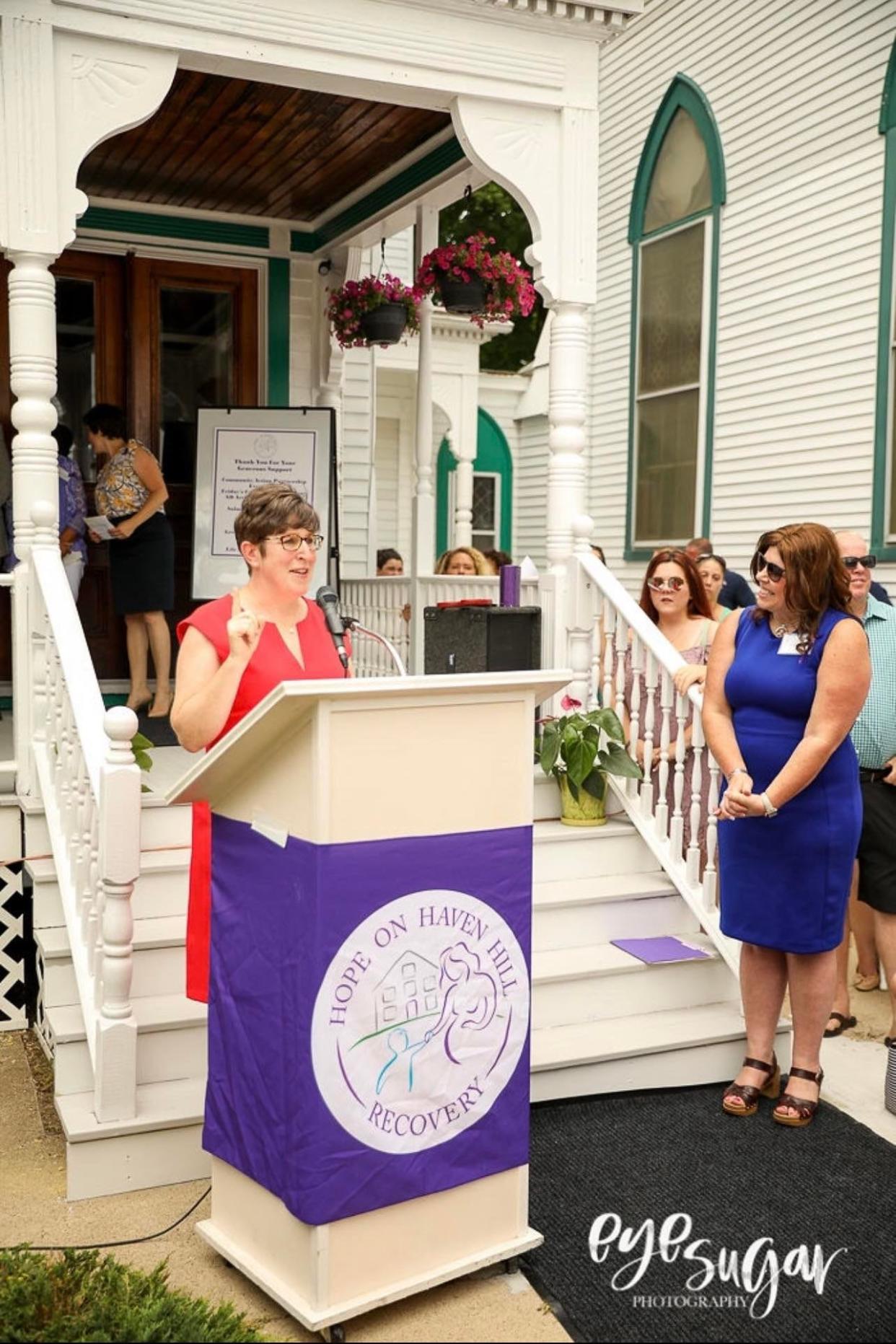Kerry Norton, Executive Director of Hope on Haven Hill listens as Betsey Andrews Parker, CEO of Community Action Partnership of Strafford County, speaks at the dedication of Abi's Place.
(Photo: courtesy)