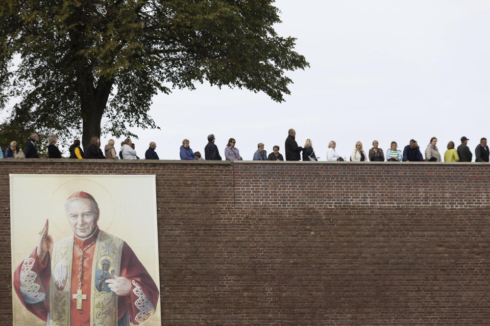 People attend a Mass celebration at the Jasna Gora Monastery, Poland's most revered Catholic shrine, in Czestochowa, Poland, Sunday, Sept. 24, 2023. As the ruling conservative Law and Justice party seeks to win an unprecedented third straight term in the Oct. 15 parliamentary election, it has sought to bolster its image as a defender of Christian values and traditional morality. Yet more and more Poles appear to be questioning their relationship with the Catholic church, and some cite its closeness to the government as a key reason. (AP Photo/Michal Dyjuk)