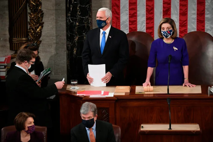 FILE - Vice President Mike Pence presides over a joint session of Congress as it convenes to count the Electoral College votes cast in November's election, at the Capitol in Washington, Jan. 6, 2021. Speaker of the House Nancy Pelosi, D-Calif., stands at right. Pence did not bend to President Donald Trump’s extraordinary pressure to intervene and presided over the count in line with his ceremonial role. He announced the certification of Biden’s victory before dawn, hours after a mob of Trump’s supporters violently ransacked the building. (Saul Loeb/Pool via AP, File) ORG XMIT: WX106