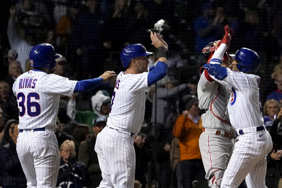 Chicago Cubs' Christopher Morel, right, celebrates his three-run home run off Philadelphia Phillies starting pitcher Aaron Nola with Alfonso Rivas and Yan Gomes during the fifth inning of a baseball game Wednesday, Sept. 28, 2022, in Chicago. (AP Photo/Charles Rex Arbogast)