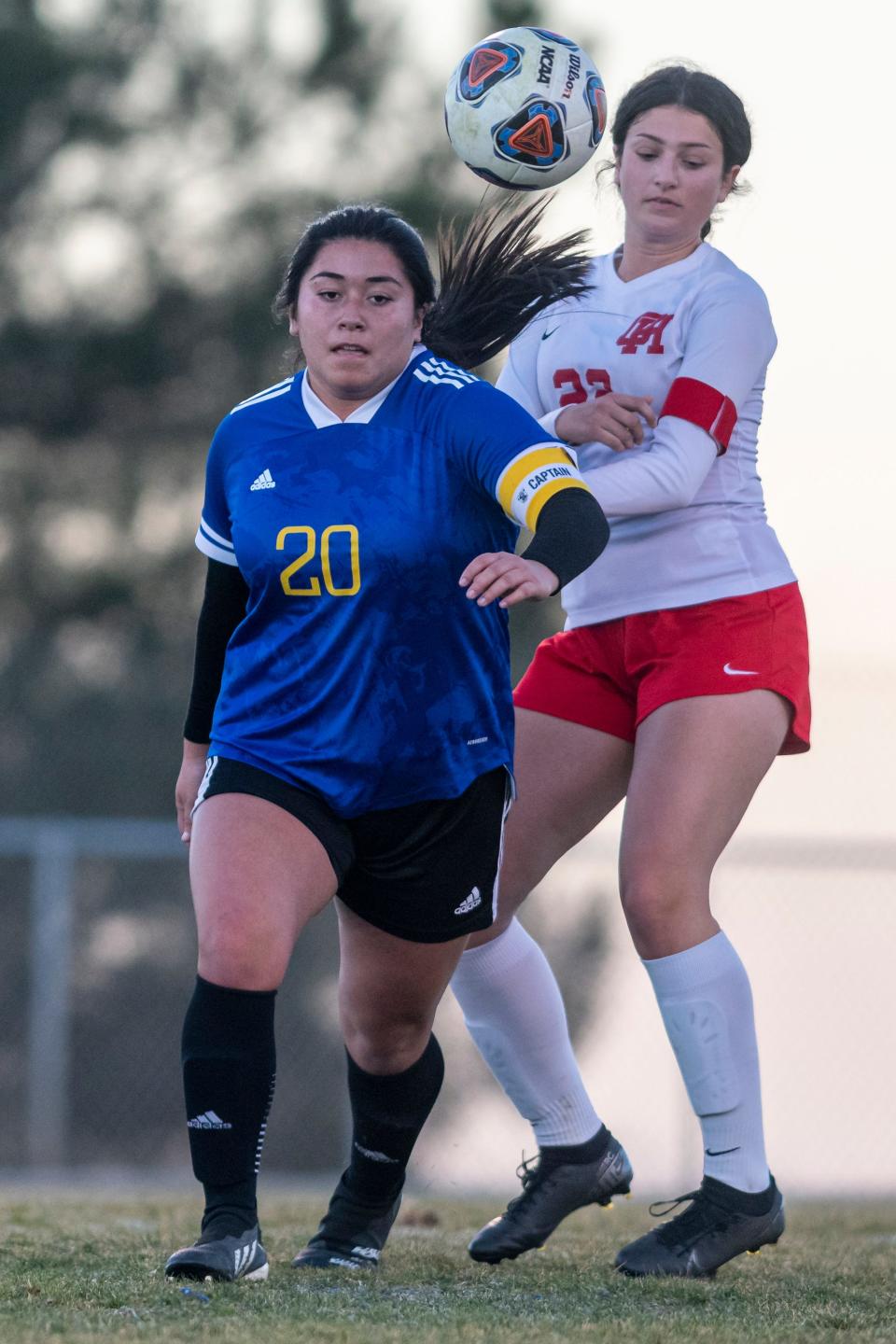 Serrano’s Samantha Favela, left, and Oak Hills Leila Martin chase down a loose ball during the first half in Phelan on Wednesday, Jan. 19, 2022. Oak Hills won 4-0.