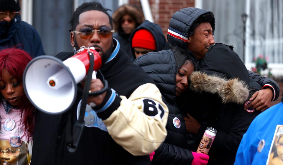 Daizon Brown, 32, of Highland Park, far right, cries while hugging other cousins of Kiazia Miller in front of her home during a memorial by family and friends in Detroit on Saturday, Nov. 19, 2022. Miller, who was having a mental health crisis at the time, was shot and killed by Detroit Police officers. Two officers and one supervisor were later suspended pending a review.