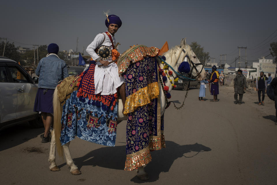 A Nihang or a Sikh warrior rides his decorated horse as farmers start vacating the protest site in Singhu, on the outskirts of New Delhi, India, Saturday, Dec. 11, 2021. Tens of thousands of jubilant Indian farmers on Saturday cleared protest sites on the capitalâ€™s outskirts and began returning home, marking an end to their year-long demonstrations against agricultural reforms that were repealed by Prime Minister Narendra Modi's government in a rare retreat. (AP Photo/Altaf Qadri)