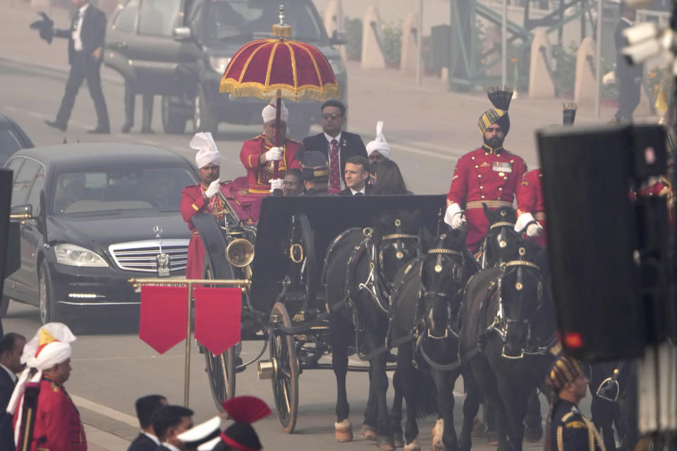 Indian President Droupadi Murmu with her French counterpart Emmanuel Macron arrive in a ceremonial British-era horse-drawn carriage for the Republic day parade in New Delhi, India, Friday, Jan. 26, 2024. (AP Photo/Manish Swarup)