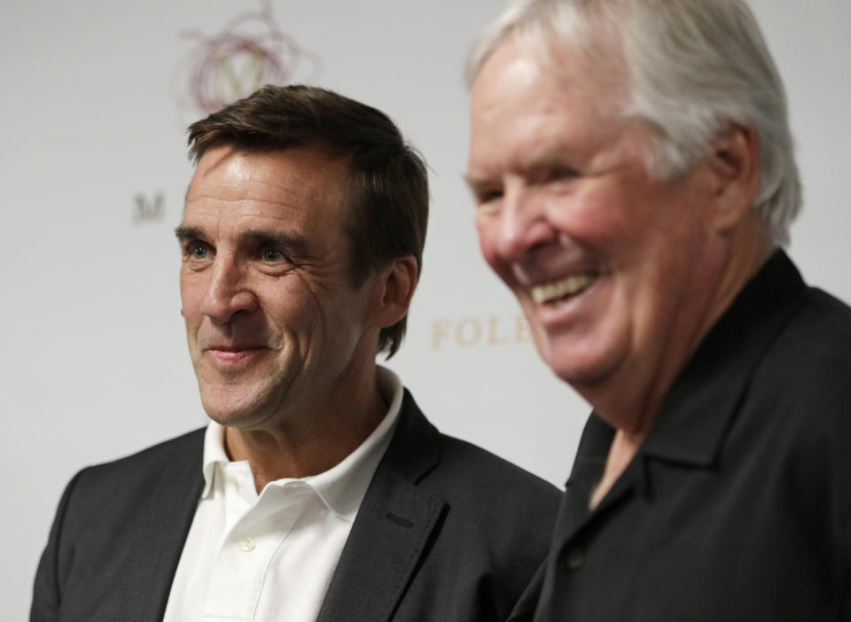 FILE - In this Wednesday, July 13, 2016, file photo, George McPhee, left, and NHL's expansion Las Vegas franchise owner Bill Foley attend a news conference in Las Vegas. The expansion Vegas Golden Knights can begin making trades and signing free agents for next season as soon as Foley’s final payment clears. The expansion draft is almost four months away, but Vegas could get some clarity and some assets very soon. “We’ve been talking with teams here for a few weeks now,” general manager McPhee said. “Teams are looking for some certainty with their rosters and obviously trying to improve their rosters before the trading deadline and they want to talk to us to see if there’s a player that we could agree upon that for a couple months from now to claim, which would make their life easier.” (AP Photo/John Locher, File)