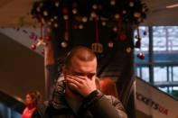 An anxious relative awaits news of the crashed Ukraine International Airlines flight at Boryspil airport outside Kiev