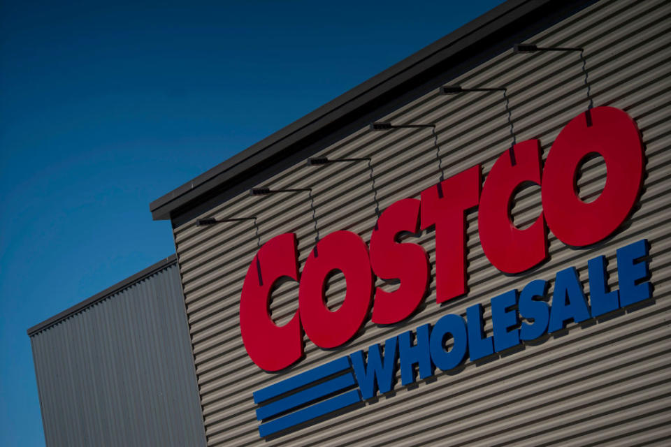 Large Costco Wholesale store sign on a building with a blue sky background