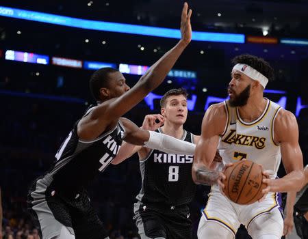 March 24, 2019; Los Angeles, CA, USA; Los Angeles Lakers center JaVale McGee (7) moves to the basket against Sacramento Kings forward Harrison Barnes (40) and guard Bogdan Bogdanovic (8) during the second half at Staples Center. Mandatory Credit: Gary A. Vasquez-USA TODAY Sports