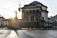 The sun shines behind the Gran Madre di Dio church in Turin, Italy on Saturday, March 21, 2020, during the country-wide lockdown due to the COVID-19 coronavirus. (Fabio Ferrari/LaPresse via AP)