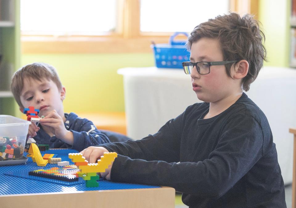 Crosby Rante, 9, right, of Canal Fulton along with Paul Picciano, 4, of East Canton work on projects during the Lego/Duplo Club at the Stark Library East Canton Branch.