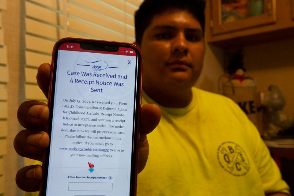 Carlos Medina holds the July 2021 notice telling him his Deferred Action for Childhood Arrivals petition was received. The petition is currently on hold as DACA's legality is argued in the court system.