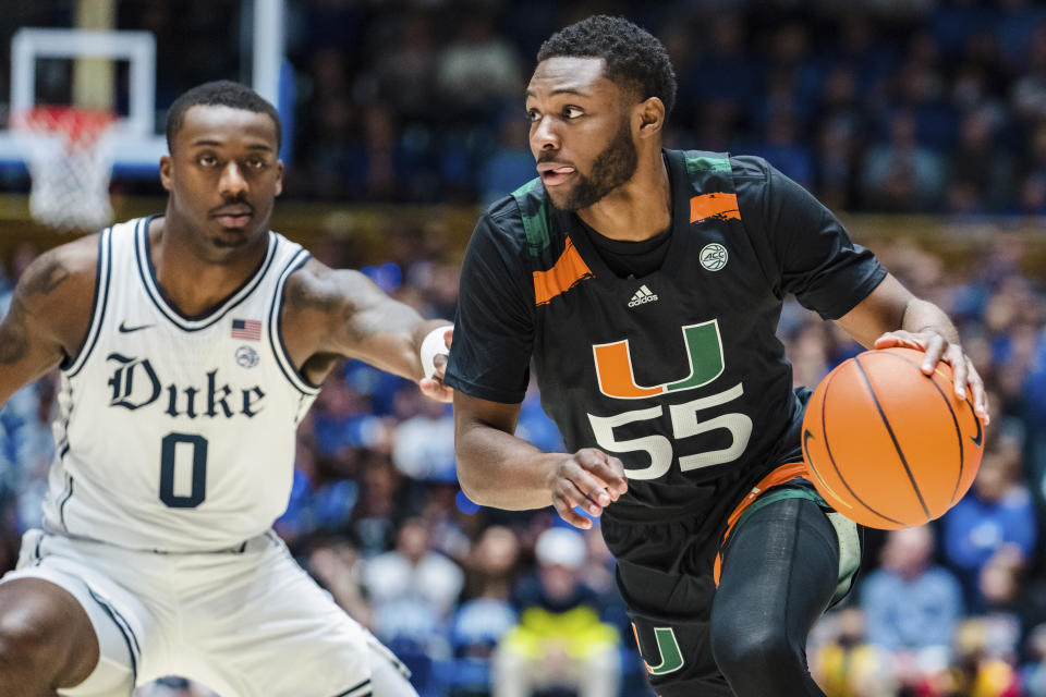 Miami guard Wooga Poplar (55) drives to the basket past Duke forward Dariq Whitehead (0) in the first half of an NCAA college basketball game on Saturday, Jan. 21, 2023, in Durham, N.C. (AP Photo/Jacob Kupferman)