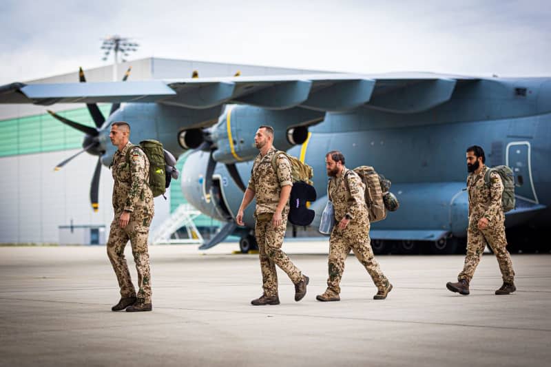 Bundeswehr soldiers leave a German Air Force Airbus A400M transport plane that had recently landed at Wunstorf Air Base in the Hanover region. The German armed forces have ended an eight-year deployment in Niger after handing over control of a key air base in the West African country. Moritz Frankenberg/dpa