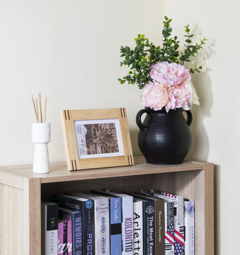 black decor pot on top of book shelf