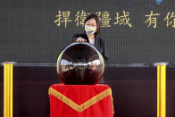 Taiwan's President Tsai Ing-wen touches a ceremonial orb to inaugurate the production of domestically-made submarines at CSBC Corp's shipyards in the southern city of Kaohsiung, Taiwan on Tuesday, Nov. 24, 2020. The move marks a step forward for the island's defense strategy at a time of elevated tensions with China. (AP Photo/Huizhong Wu)