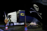 A protester wearing a yellow vest speaks to a lorry driver at a roundabout in Fontaine-Notre-Dame, France, December 10, 2018. REUTERS/Pascal Rossignol