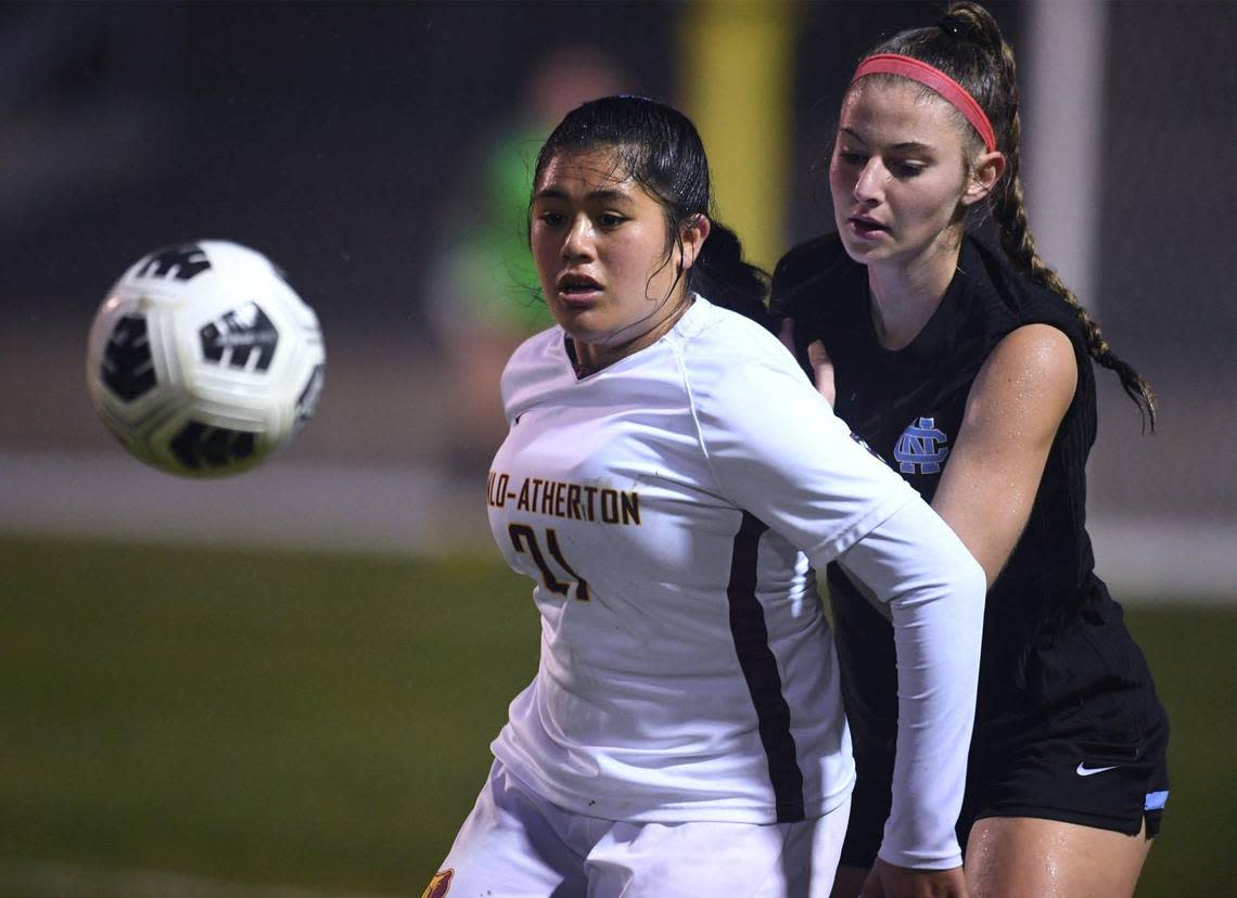 Menlo-Atherton’s Valerie Latu-Nava, left, eyes the ball with Clovis North’s Kaylin Wheeler to the right in the CIF Northern California Regional girls playoff game Tuesday, Feb. 2, 2023 in Clovis.