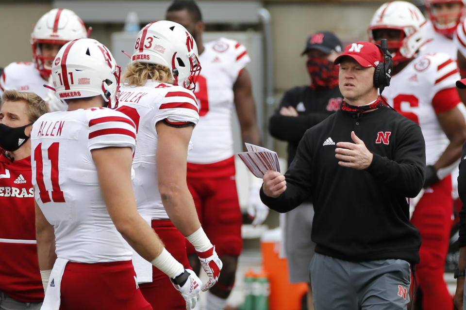 Nebraska head coach Scott Frost, right, talks with players during the first half of their NCAA college football game against Ohio State Saturday, Oct. 24, 2020, in Columbus, Ohio. Ohio State defeated Nebraska 52-17. (AP Photo/Jay LaPrete)