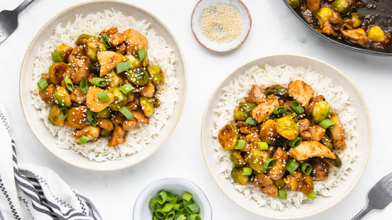 Chicken Brussels sprouts stir fry with rice in bowls