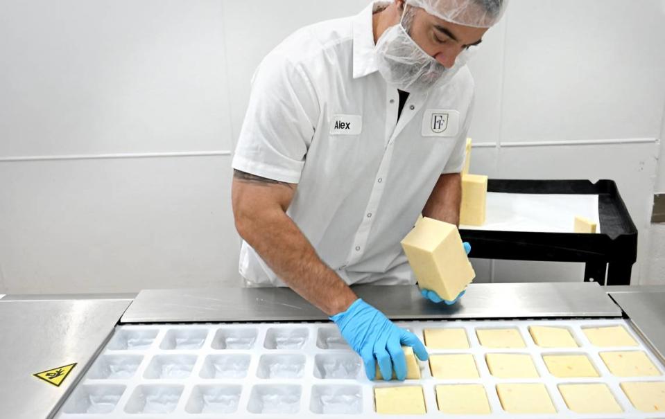 Operations manager Alex Borgo demonstrates the cheese packaging machine at Fiscalini Farmstead in Modesto, Calif., Wednesday, April 10, 2024.
