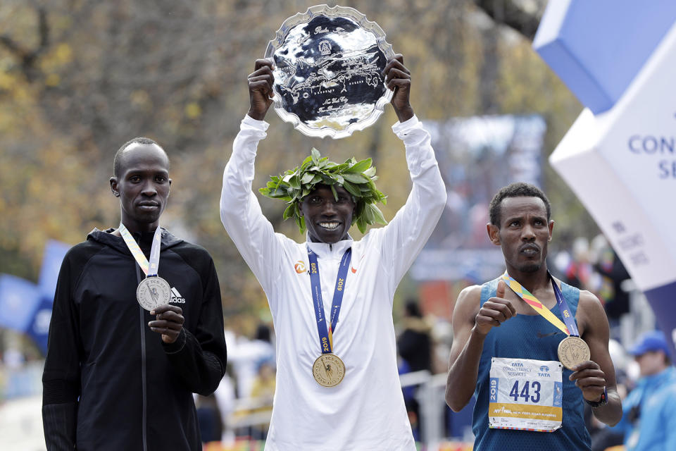 Geoffrey Kamworor, center, of Kenya, men's winner of the New York City Marathon, is flanked by second place finisher and countryman Albert Korir, left, and third place finisher Girma Bekele Gebre, of Ethiopia, as they pose for photos in New York's Central Park, Nov. 3, 2019. (Photo: Richard Drew/AP)