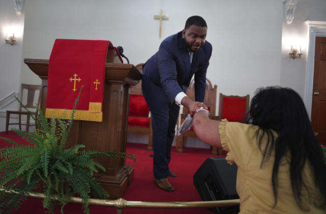 The Rev. M. Andrew Davis shakes hands with congregant Calvernetta Williams, who has worshipped at Zion for 40 years, at the end of service on Sunday, April 16, 2023, in Columbia, S.C. (AP Photo/Jessie Wardarski)