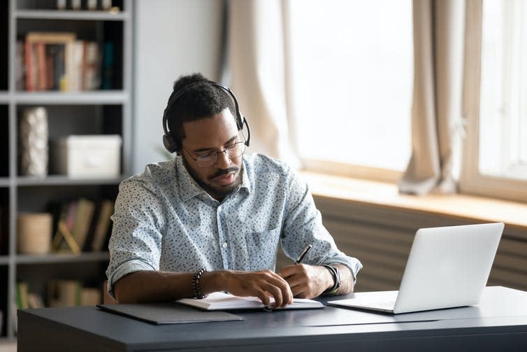 A man working on a laptop at home