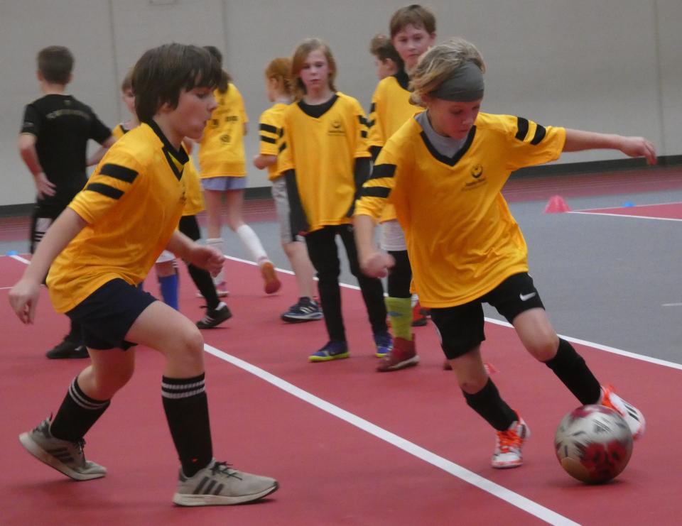 Jett Marcum, 8, dribbles against Miles Ruoop, 9, during a camp hosted by the Rotary Club of Granville and Denison University to benefit the Royal Seed Orphanage & School in Ofaakor, Ghana, through the Jonathan Mensah Foundation on Jan. 15, 2023.