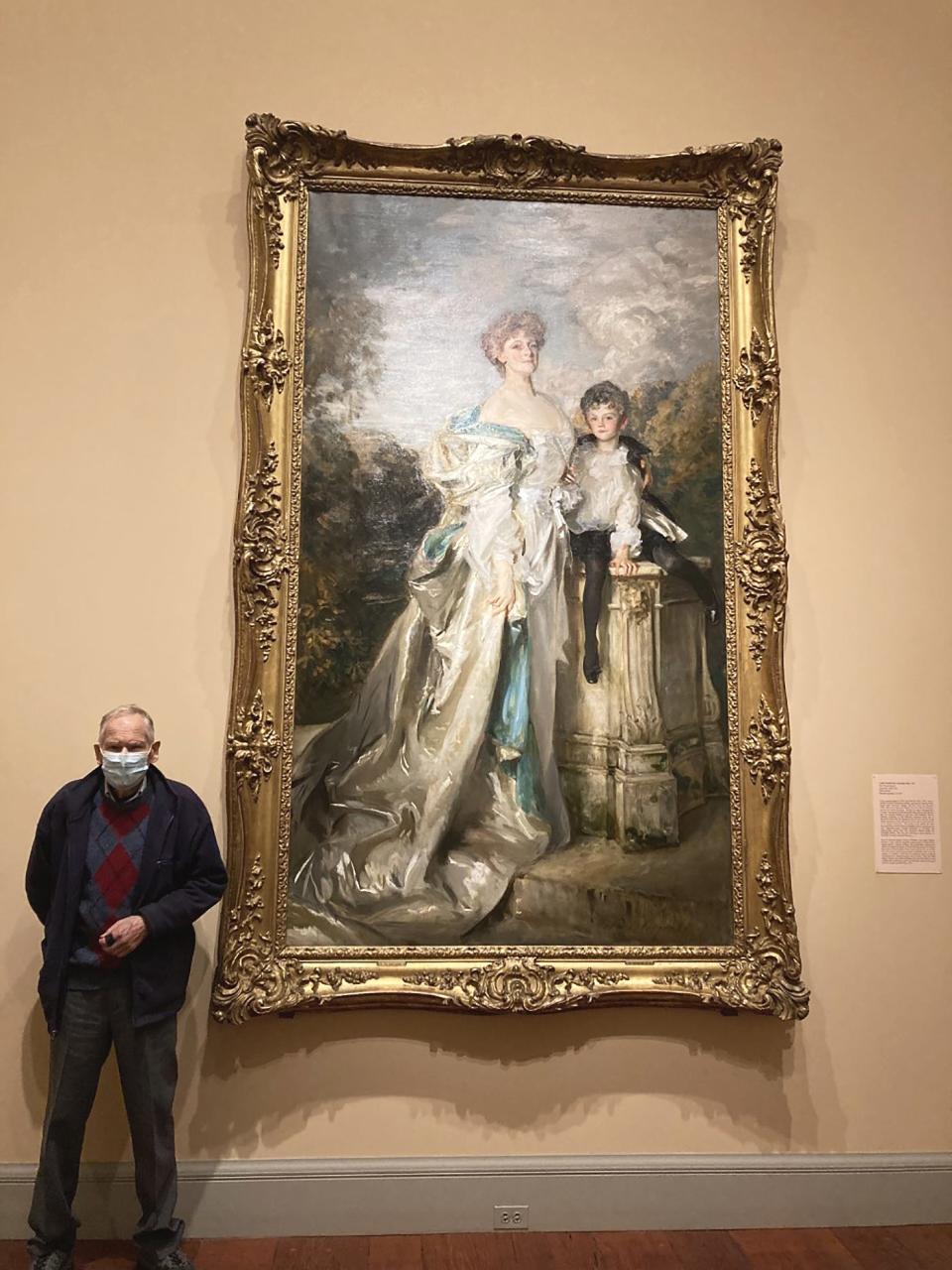 Gerry Gariepy stands beside the portrait “Lady Warwick and Her Son” by John Singer Sargent.