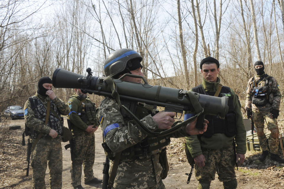 FILE - Ukrainian servicemen study a Sweden shoulder-launched weapon system Carl Gustaf M4 during a training session on the near Kharkiv, Ukraine, April 7, 2022. Western weaponry pouring into Ukraine helped blunt Russia's initial offensive and seems certain to play a central role in the approaching battle for Ukraine's contested Donbas region. Yet the Russian military is making little headway halting what has become a historic arms express. (AP Photo/Andrew Marienko, File)