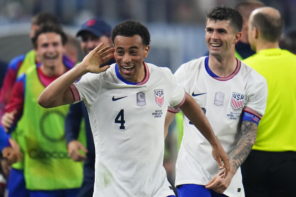 United States midfielder Tyler Adams (4) celebrates his goal with forward Christian Pulisic during the first half of a CONCACAF Nations League final soccer match against Mexico, Sunday, March 24, 2024, in Arlington, Texas. (AP Photo/Julio Cortez)