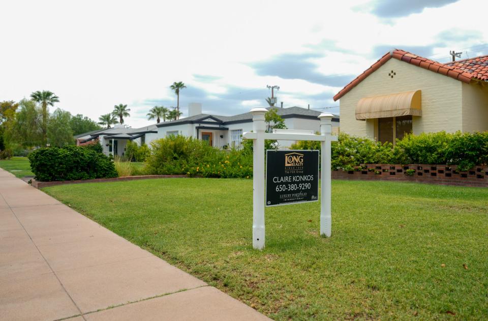 A for sale sign is posted outside of a home in Phoenix.