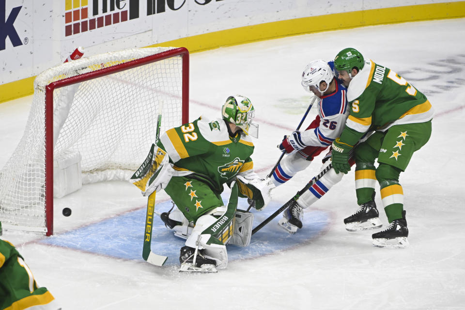 New York Rangers right wing Jimmy Vesey (26) scores a goal past Minnesota Wild goalie Filip Gustavsson (32) next to Wild defenseman Jacob Middleton (5) during the first period of an NHL hockey game Saturday, Nov. 4, 2023, in St. Paul, Minn. (AP Photo/Craig Lassig)