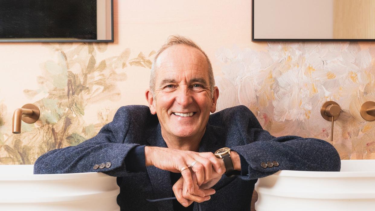 Kevin McCloud posing in a bathroom