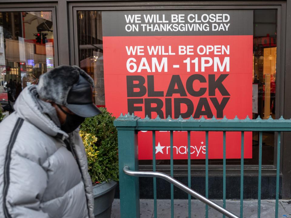 black friday macysNEW YORK, NEW YORK - NOVEMBER 20: A man wearing a mask walks past a Black Friday sign displayed at Macy's Herald Square on November 20, 2020 in New York City. The pandemic has caused long-term repercussions throughout the tourism and entertainment industries, including temporary and permanent closures of historic and iconic venues, costing the city and businesses billions in revenue. (Photo by Alexi Rosenfeld/Getty Images)